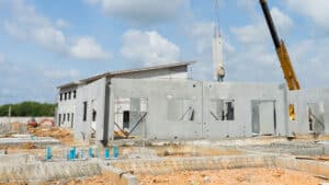 A construction site with precast concrete walls being installed, highlighting sustainable and efficient building.