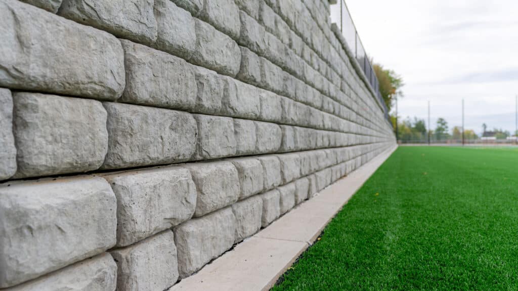 Large sculptural precast concrete blocks create a functional retaining wall at recreational facility in Utah